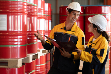 Wall Mural - two professional engineer,worker,technician use clipboard discuss work, walk in steel metal manufacture factory plant industry. Black African American man and woman wear hard hat check quality machine