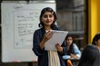 © Mikhail Vorobev - Indian female presenter leading diverse colleagues in business project presentation