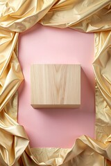 Canvas Print - Wooden cube with golden fabric draped around a pink backdrop.