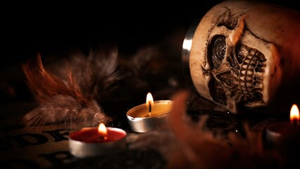 Creepy Skull on a Witchcraft Ouija Board and Candles