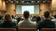 © forenna - Audience from Rear in Seminar Meeting Room - Large Screen Displaying Video Presentation, Business Education and Corporate Training for Workers and Employees Photo