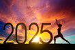 © Creativa Images - Silhouette of a woman exercising yoga with 2025 new year numbers