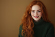 © ALL YOU NEED studio - beautiful young redhead wavy red woman smiling candid , wearing dark green knitted sweater isolated on smooth solid brown background with copy space