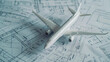 © VK Studio - A miniature model airplane rests on top of detailed blueprints, merging the concepts of aviation design and precision engineering.