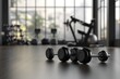 © Fariha - 3D rendering, dumbbells on the floor in concept fitness room with training equipments in the back