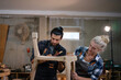 © Suney - Carpenters are working together at workshop.