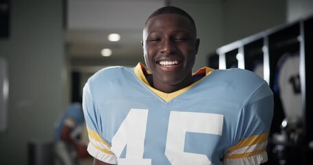 Wall Mural - Black man, face and American football player in locker room with smile for sports, contest and ready for game. Person, athlete and happy in portrait for competition, stadium and franchise in Florida