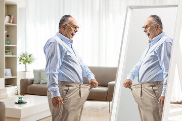 Sticker - Mature man trying on a pair of pants in front of a mirror