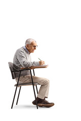 Canvas Print - Senior sitting in a schoolchair and writing