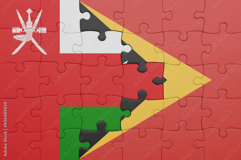 puzzle with the colourful national flag of oman and flag of east timor ...