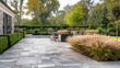 © K2Kstock - Backyard patio with stone pavers with low fence in the background