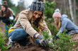 © Kanurism - Volunteers plant trees together in a nature campaign