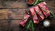 © ArtificialHorizons - Fresh beef short ribs on wooden table top view with copy space