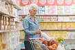 © StockPhotoPro - Elderly woman buying groceries at the supermarket