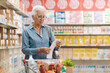 © StockPhotoPro - Disappointed senior customer checking the grocery receipt