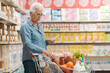 © StockPhotoPro - Senior woman checking her grocery list at the supermarket