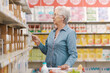 © StockPhotoPro - Senior lady doing her shopping at the supermarket