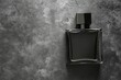 © Zaleman - The top view of a black fragrance perfume bottle mockup on a dark empty background. Horizontal orientation.
