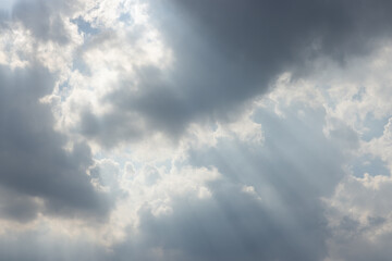Wall Mural - The sky is cloudy and the sun is shining through the clouds