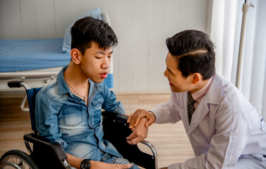 Doctor comforting a young patient in a wheelchair, offering care and support in a medical setting. Compassionate healthcare professional.