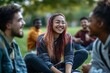 © Dina - group of diverse students sitting on the grass at university campus , enjoying a lunch break together with laughter and conversation, minimal style with copy space. Networking. Back to school.