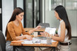 © aekachai - Asian business woman Discussing business documents in the office