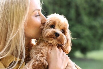 Wall Mural - Beautiful young woman with cute dog in park