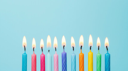 A row of colorful birthday candles lit against a blue background, symbolizing celebration and joy.