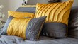 © Darya - A stylish arrangement of gray and yellow decorative pillows sits comfortably on a plush bedspread, enhancing the warmth of the inviting bedroom decor