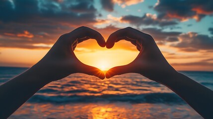 Heart Shape Hand Gesture: Two hands forming a heart shape with a sunset beach scene in the background.
