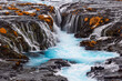 © robertharding - The incredibly colorful details of the famous Bruarfoss waterfall, with its turquoise water and golden grass, taken on a cold winter day, Iceland, Polar Regions