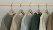 © pvl0707 - A Display of Cozy Knit Sweaters Hanging on a Wooden Rack