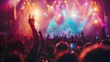 © mashimara - Concert crowd with colorful stage lights and raised hands, creating a vibrant and energetic atmosphere.