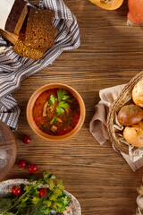 Wall Mural - Kharcho Soup with Beef, Spices, and Rice Presented on Wooden Table with Rustic Bread