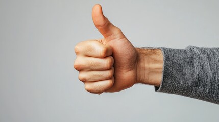 a hand with thumb extended, giving a thumbs-up gesture