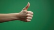© MrHamster - Hand Gesturing Thumbs Up Against Green Background