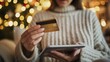 © AlfaSmart - Woman holding a credit card and using a tablet