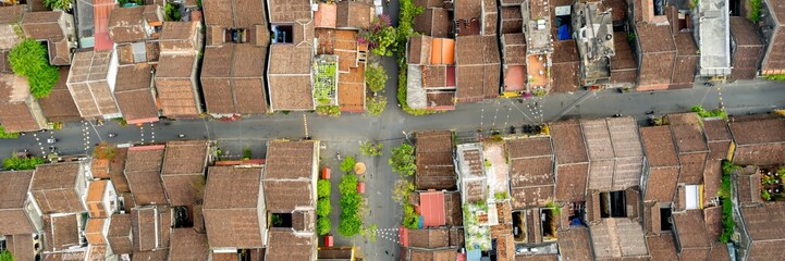 Aerial view of a traditional Asian residential neighborhood with narrow streets and old houses, depicting Asian urban living