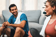© InfiniteFlow - Athletic body and sporty young couple or workout buddy in sportswear warmup or resting after finishing in home workout exercise at gaiety home exercise and healthy lifestyle concept.