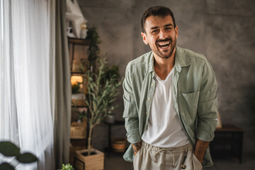 Wall Mural - portrait of adult man stand and smile at home