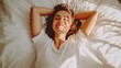 © Nicat - Gorgeous woman stretching and grinning as she wakes up in her bed. Beautiful young woman, well-rested when she wakes up in bed. Stretching in bed after waking up is a woman. wholesome way of life. con