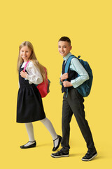 Poster - Cute pupils with backpacks on yellow background