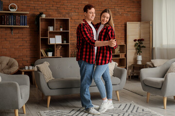 Poster - Happy young couple dancing at home