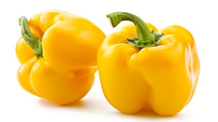 Wall Mural - Two yellow peppers are sitting on a white background