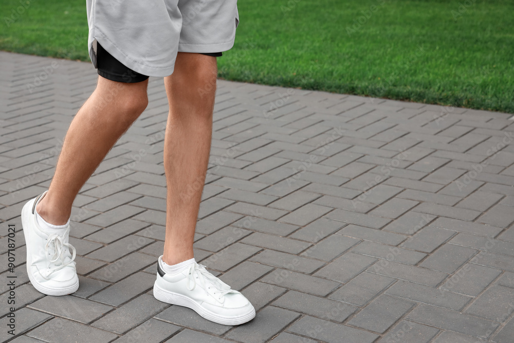 Man walking along paved road. Concept of new beginning
