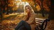 © takkan - A woman sits on a park bench during autumn, surrounded by fallen leaves and bathed in golden sunlight