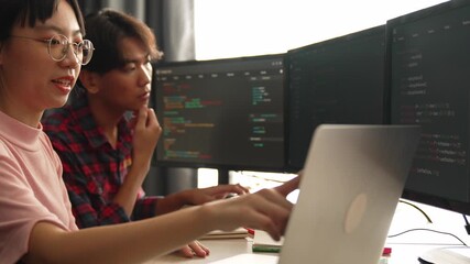 Slow motion back end software developer engineer for computer programming working together on debugging writing computing code, solving complex algorithms display on monitor in office. Burgeoning
