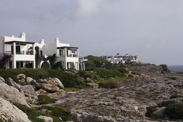 Sticker - Coastal view of white Mediterranean-style buildings on a rocky shore in Mallorca