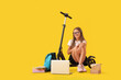 © Pixel-Shot - Cute schoolgirl with laptop, books and electric scooter on yellow background