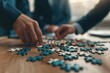 © JK_kyoto - A group of professionals in suits assembling a jigsaw puzzle in a modern office